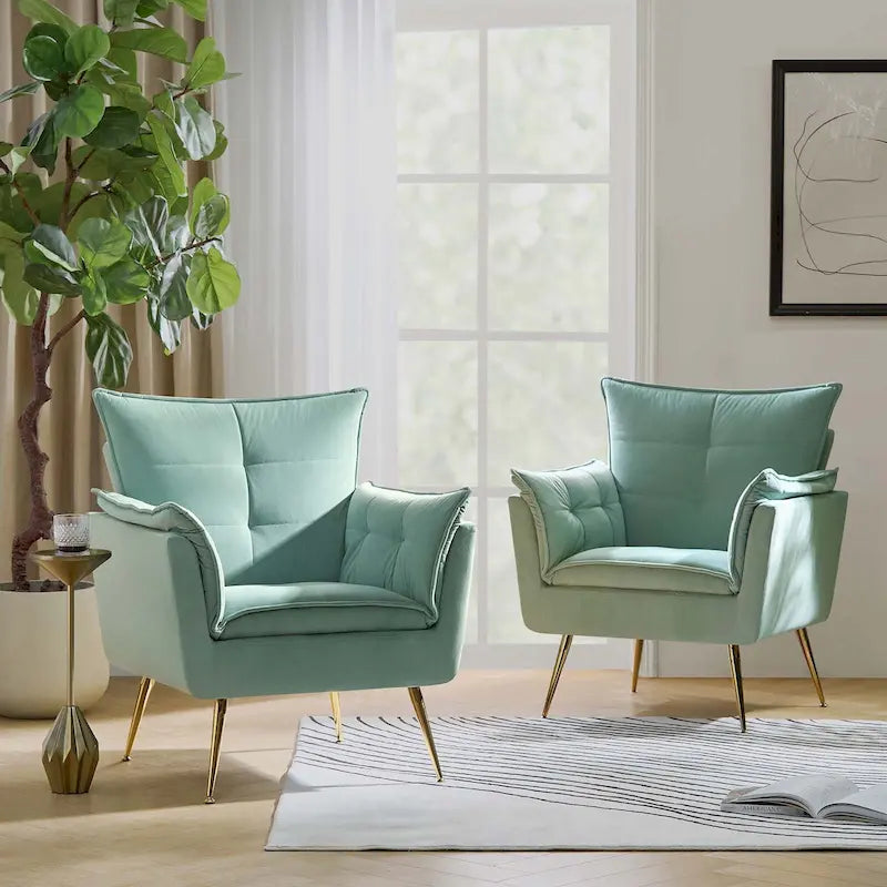 Modern velvet-cushioned armchairs with gold-tone metal legs, two-piece set.