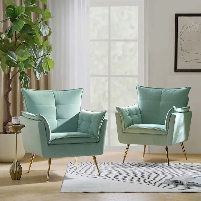 Modern velvet-cushioned armchairs with gold-tone metal legs, two-piece set.